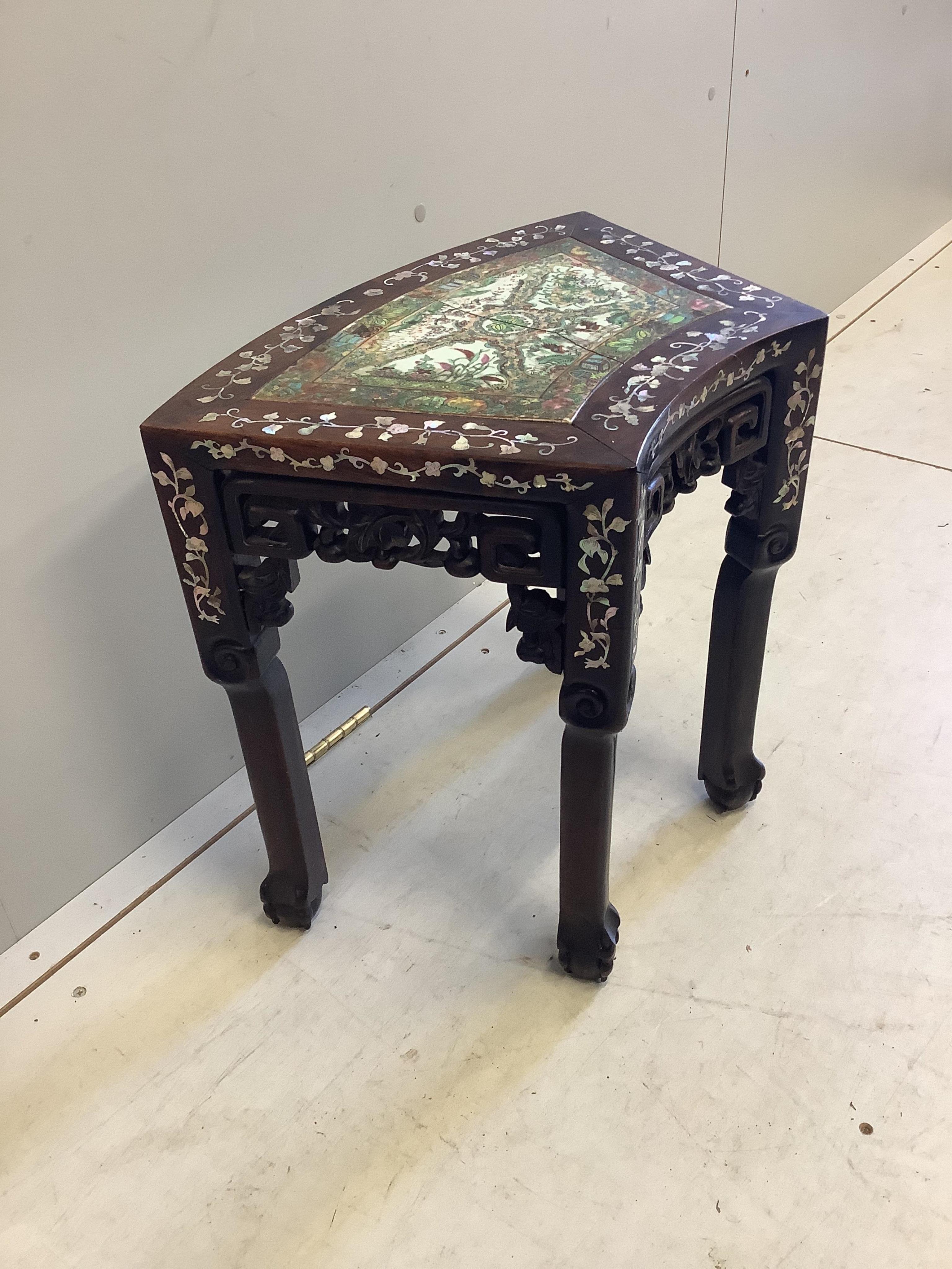 A Chinese mother of pearl inlaid hongmu vase stand, with famille rose porcelain inset top, (cracked), width 49cm, depth 31cm, height 47cm